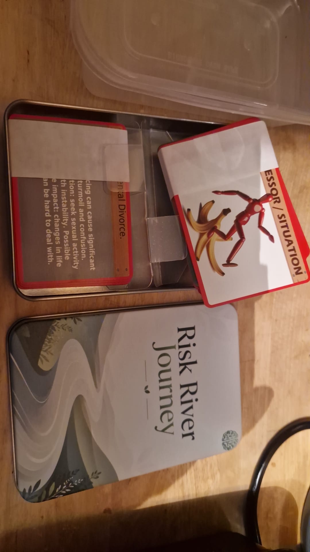 Risk River Journey cards and tin together